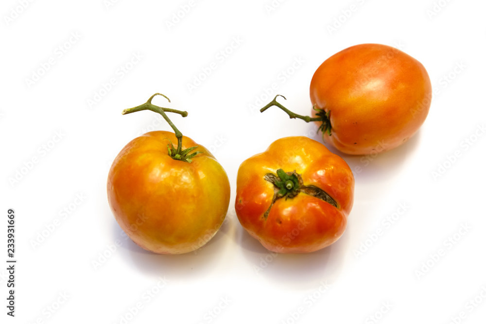 Natural organic tomatoes, green and orange on white background with shadow. Natural organic tomatoes, green and orange on white background with shadow.