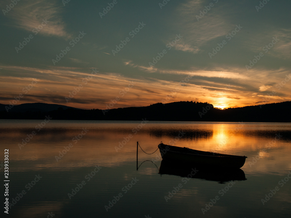 Silhouette of a boat on a lake with sunset, Lipno, Czech Republic