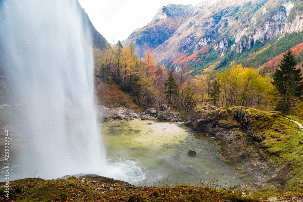 Waterfall in an autumn day in the italian alps