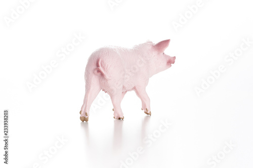 Plastic toy figurine of a pig on a white background. The symbol of the New Year in 2019