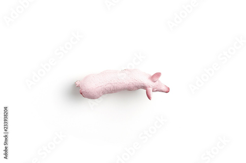 Plastic toy figurine of a pig on a white background. The symbol of the New Year in 2019