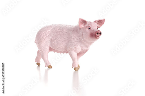 Obraz na płótnie Plastic toy figurine of a pig isolated on a white background. The symbol of the New Year in 2019 w salonie