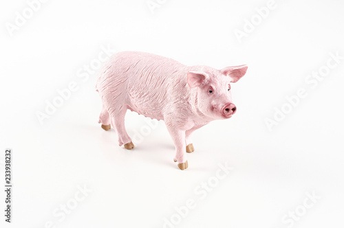 Obraz na płótnie Plastic toy figurine of a pig on a white background. The symbol of the New Year in 2019 w salonie