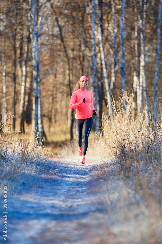 Young girl running in the park in early winter Young girl running in the park in early winter