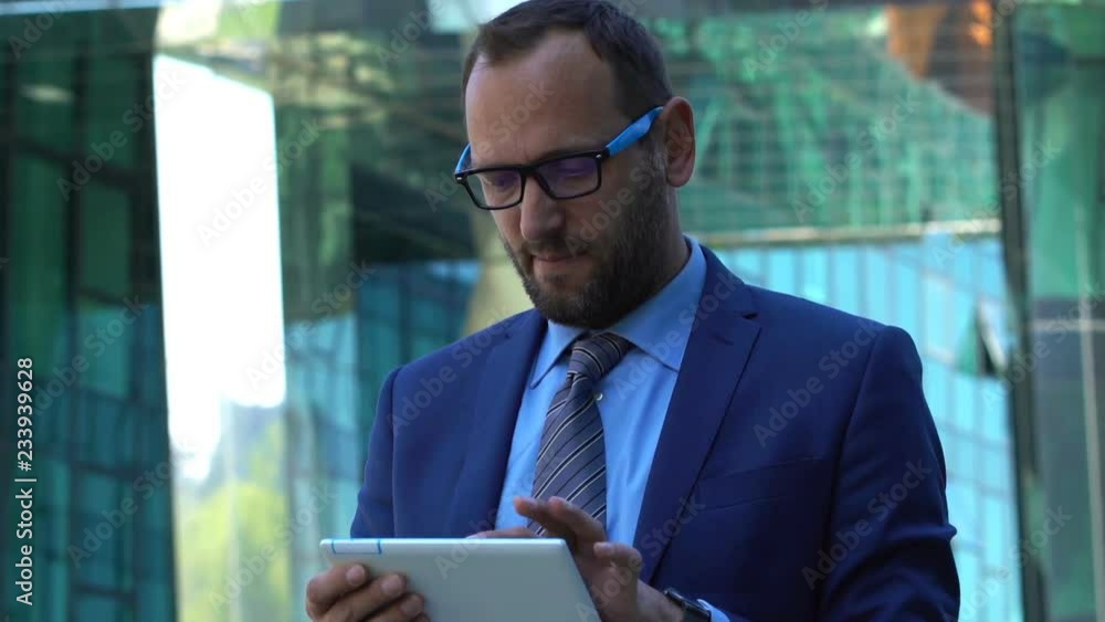 Young businessman using tablet computer in the city Young businessman using tablet computer in the city