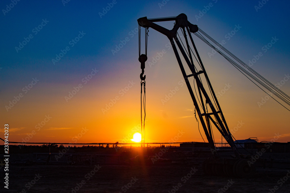trailer crane at the construction site at sunset