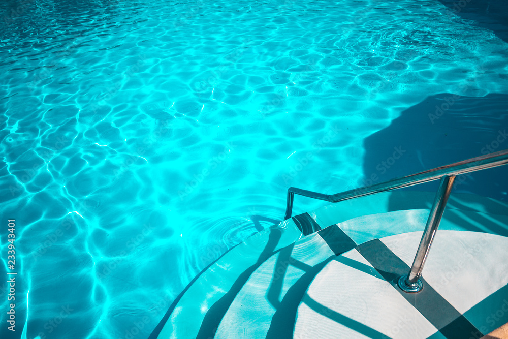 Obraz premium Swimming pool with white stairs in the hotel.