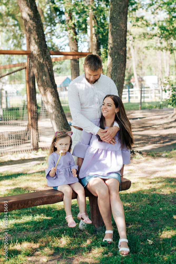 Fototapeta premium family with a little girl on nature in summer