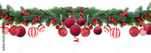 Christmas garland with red hanging balls, cones and berries on isolated white background
