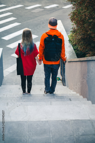 Beautiful loving teenager couple walking on the street