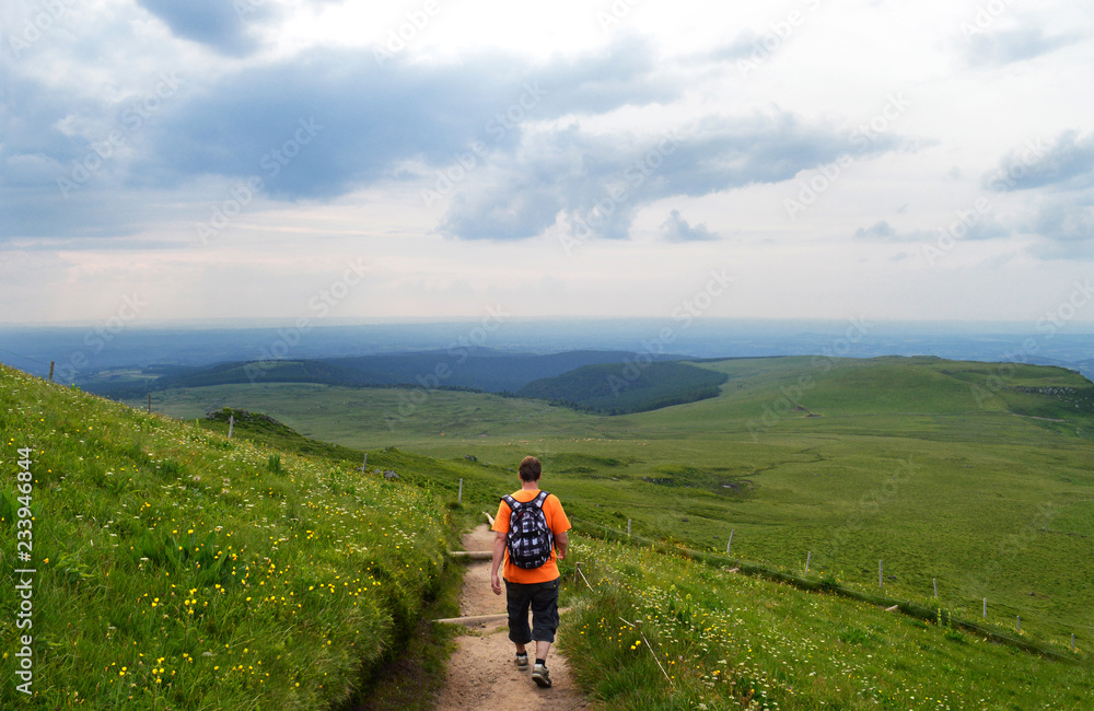 A hiker on a mountain trail in the Sancy massif in Auvergne