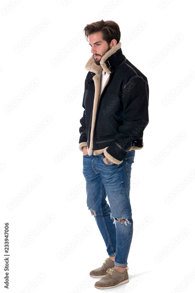 Modern young man in denim and warm jacket standing with hands in pockets isolated on white background in studio Modern young man in denim and warm jacket standing with hands in pockets isolated on white background in studio