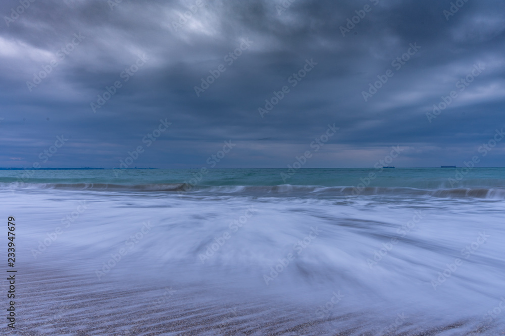 Winter morning on the beach. Cold Novemeber morning with big waves. Long exposure seascape. 