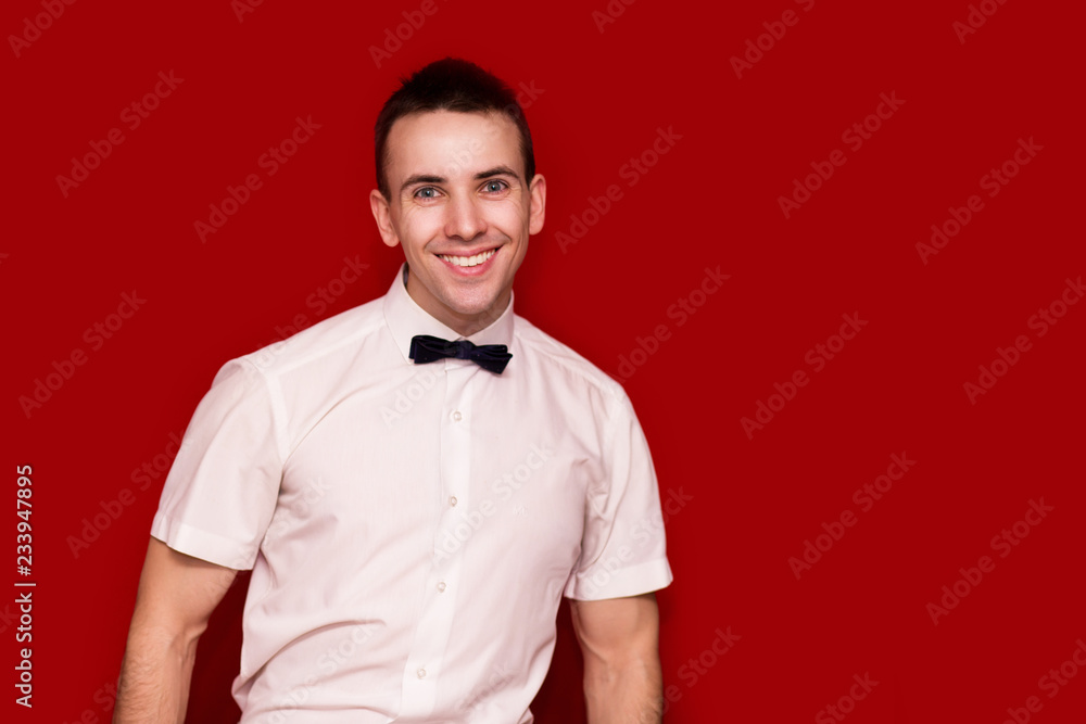Fototapeta premium Happy man in white shirt isolated on red background. Photo for business projects, product presentation.
