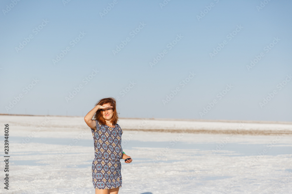 happy smiling girl enjoying sun, dancing and laughs, holds hand at his forehead happy smiling girl enjoying sun, dancing and laughs, holds hand at his forehead