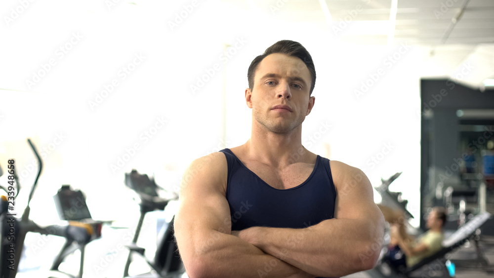 © motortion - Professional muscular personal trainer posing, gym service, sport motivation
