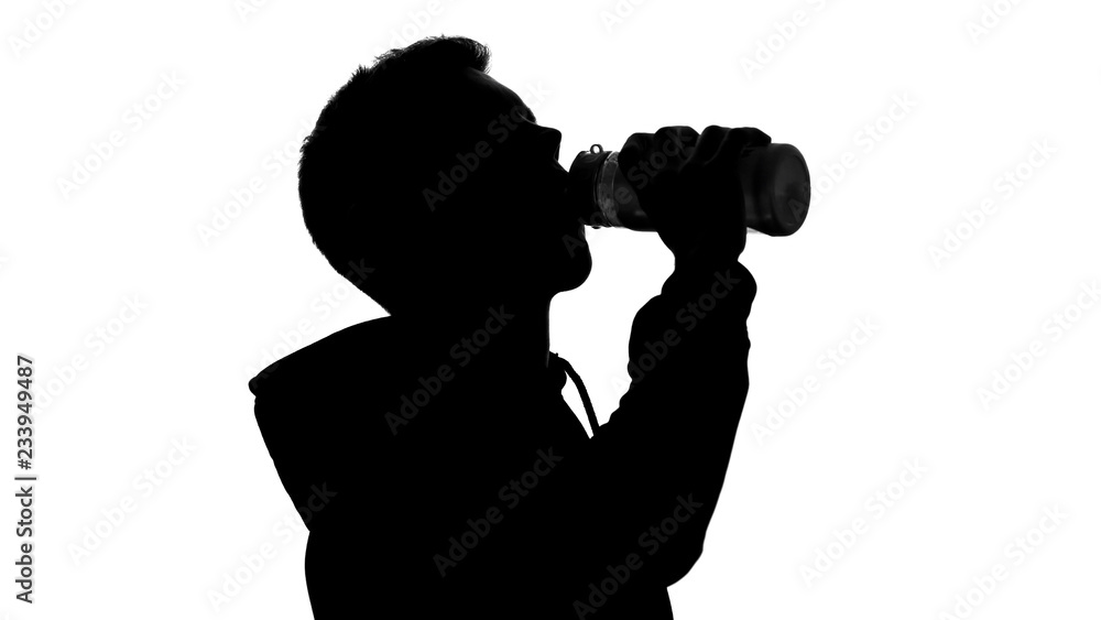 Shadow of thirsty male drinking water after workout water balance body hydration