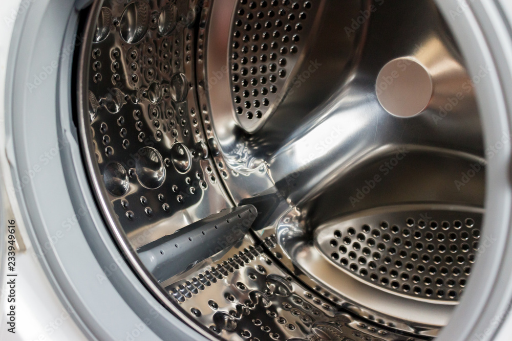Close-up photo of empty washing machine tank. Close-up photo of empty washing machine tank.