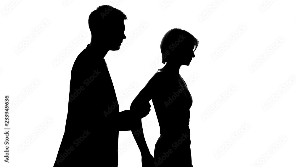 Male holding female, stopping from walking away during conversation, crisis