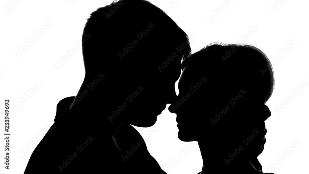 Young attractive couple silhouettes passionately kissing, strong feelings, love