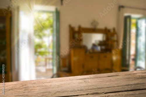 Empty wooden raw table with blurred old style kitchen in background. Ready for product montage.