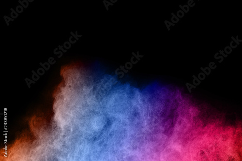 abstract colored dust explosion on a black background.abstract powder splatted background,Freeze motion of color powder exploding/throwing color powder, multicolored glitter texture.