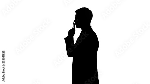 Silhouette of person showing gesture of silence, censorship, confidential data photo