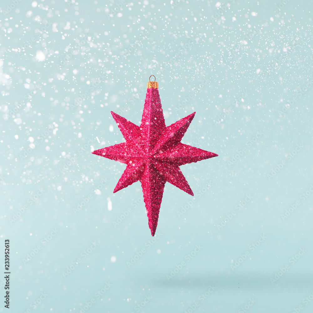 Christmas concept. Creative Christmas conception made by falling in air red bright star Christmas concept. Creative Christmas conception made by falling in air red bright star
