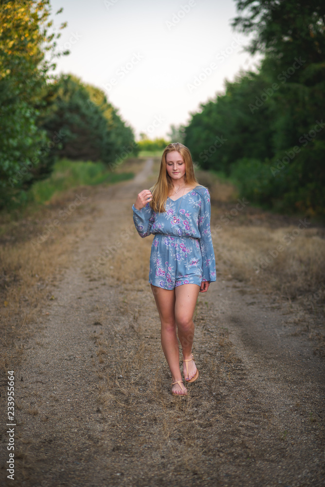 girl walking down the road in the country girl walking down the road in the country