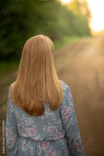 girl walking down the road in the country © Mitch