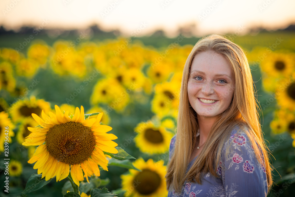 woman in a sunflower field at sunset woman in a sunflower field at sunset