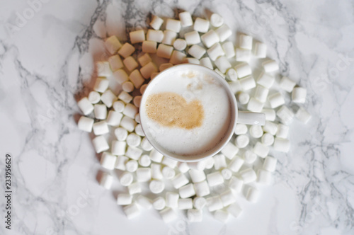 cup of hot coffee with milk and sweet marshmallows