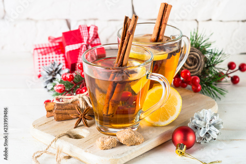 Christmas hot tea with lemon, spices and decorations
