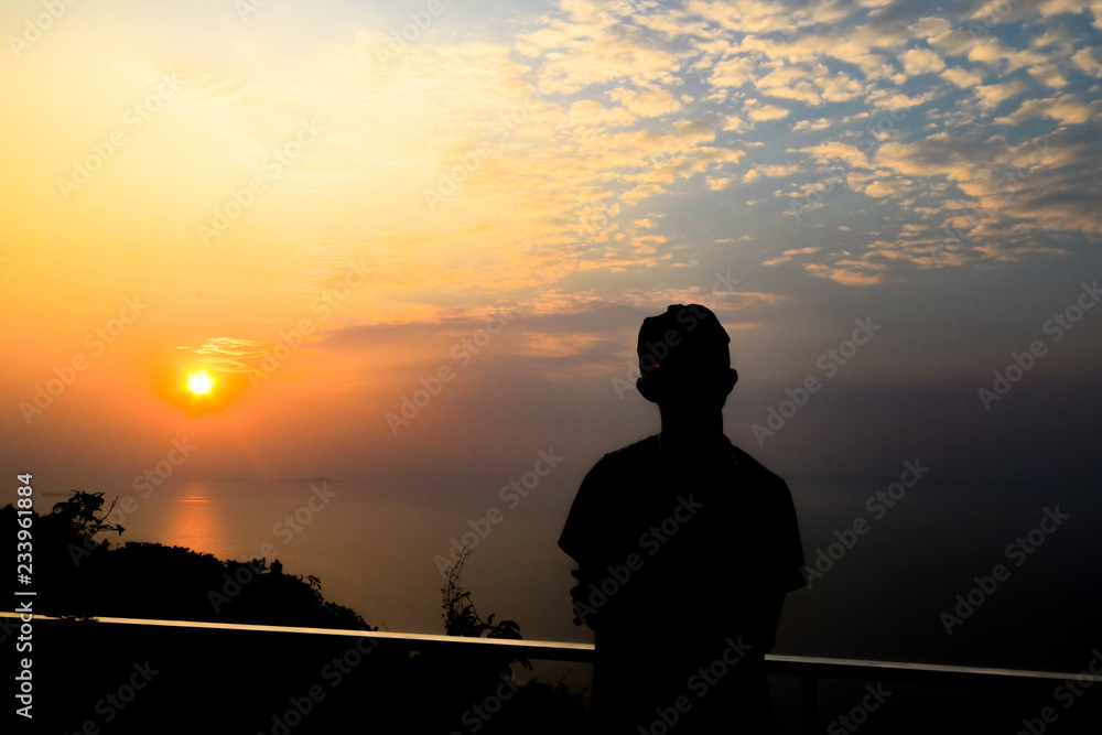 Silhouette man on the view point watching sunset