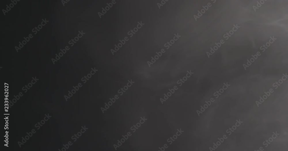 Slow motion closeup vapor floating in air on black background Slow motion closeup vapor floating in air on black background