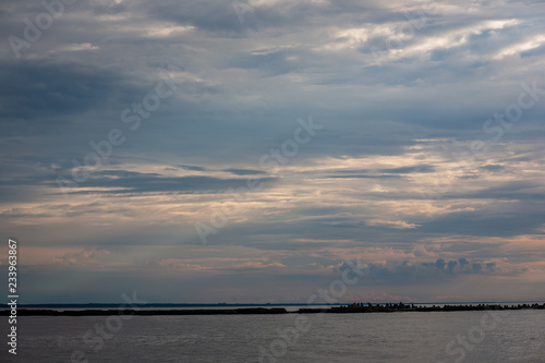 sea beach skyline with clouds and calm water