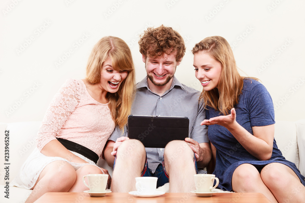 Friends relaxing browsing internet on tablet. Friends relaxing browsing internet on tablet.