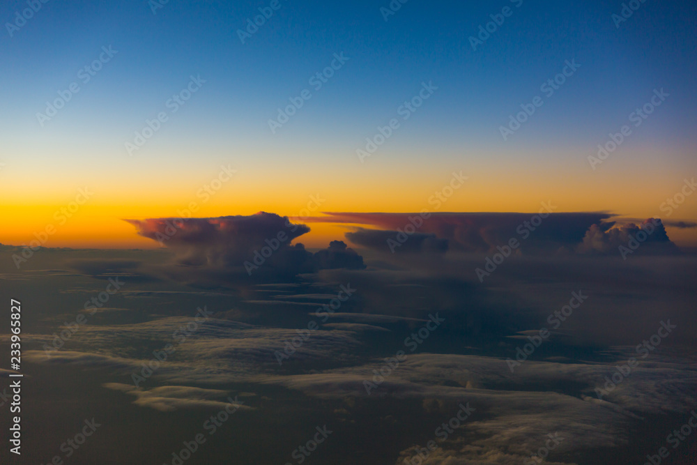 Thunderstorm clouds illuminated during sunset - inflight view Thunderstorm clouds illuminated during sunset - inflight view