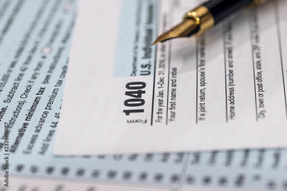 1040 individual tax form with pen on wooden table 1040 individual tax form with pen on wooden table