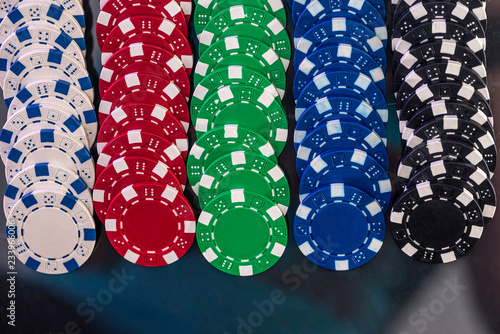 Colorful playing chips in rows on dark background