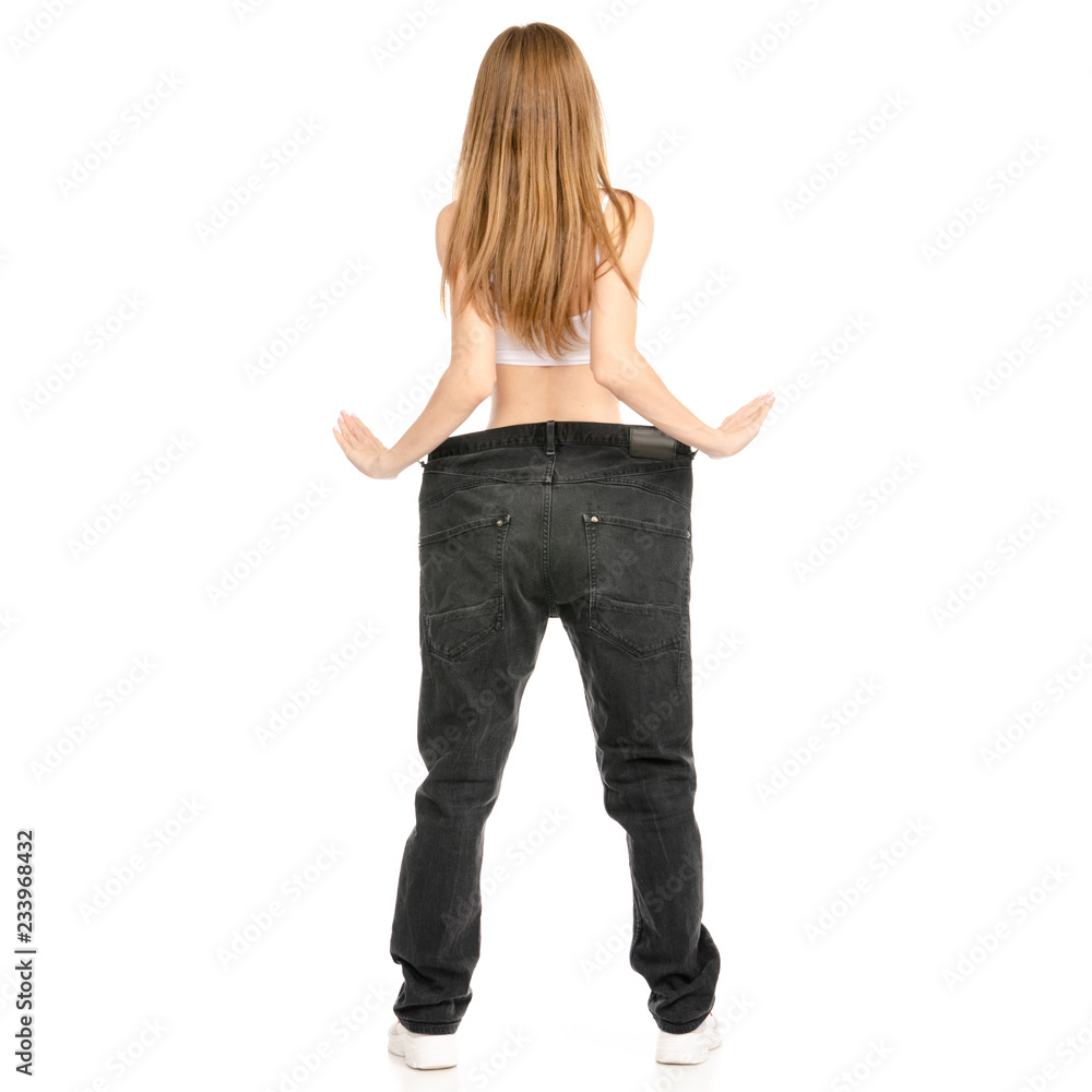 Beautiful woman weight loss big jeans on white background. Isolation Beautiful woman weight loss big jeans on white background. Isolation