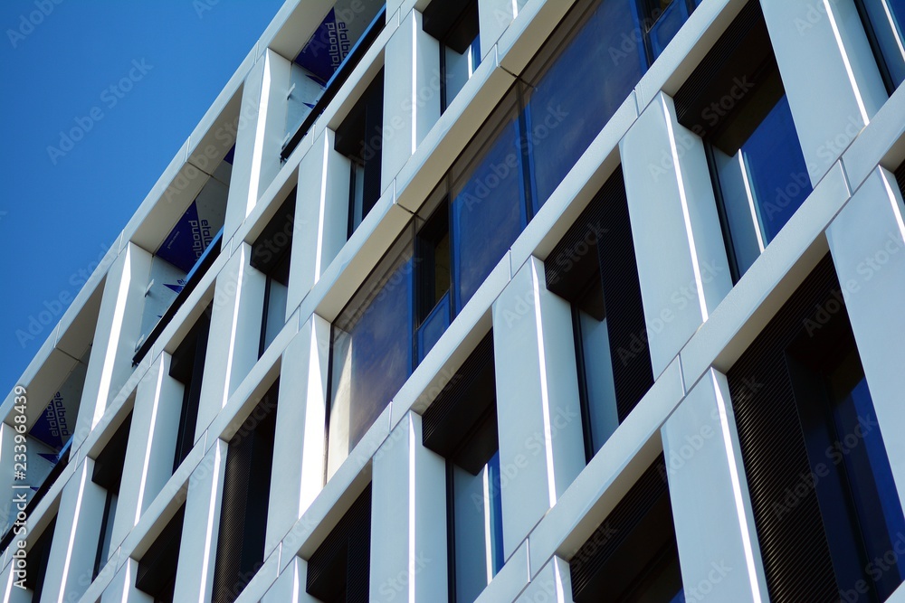 Fragment of a facade of a building with windows and balconies. Modern home with many flats. Fragment of a facade of a building with windows and balconies. Modern home with many flats.