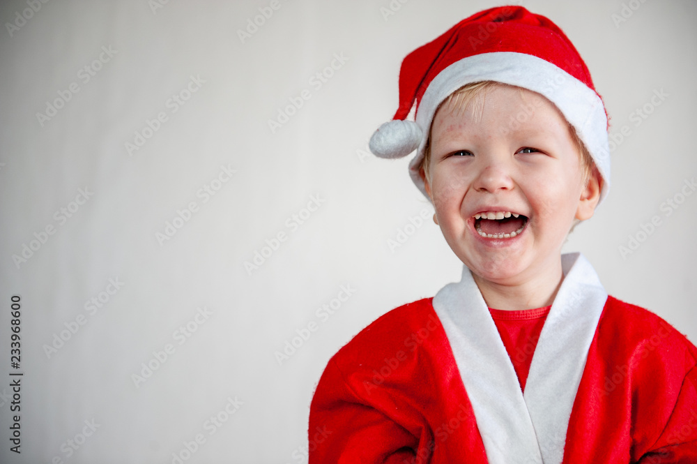 Cute boys dressed in festive costumes of Santa Claus and snowmen and decorate Christmas tree with balls and garlands. Children play and wait for gifts. Christmas Eve Cute boys dressed in festive costumes of Santa Claus and snowmen and decorate Christmas tree with balls and garlands. Children play and wait for gifts. Christmas Eve