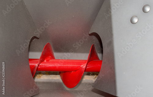 Fotografie Red screw transporter for animal feed