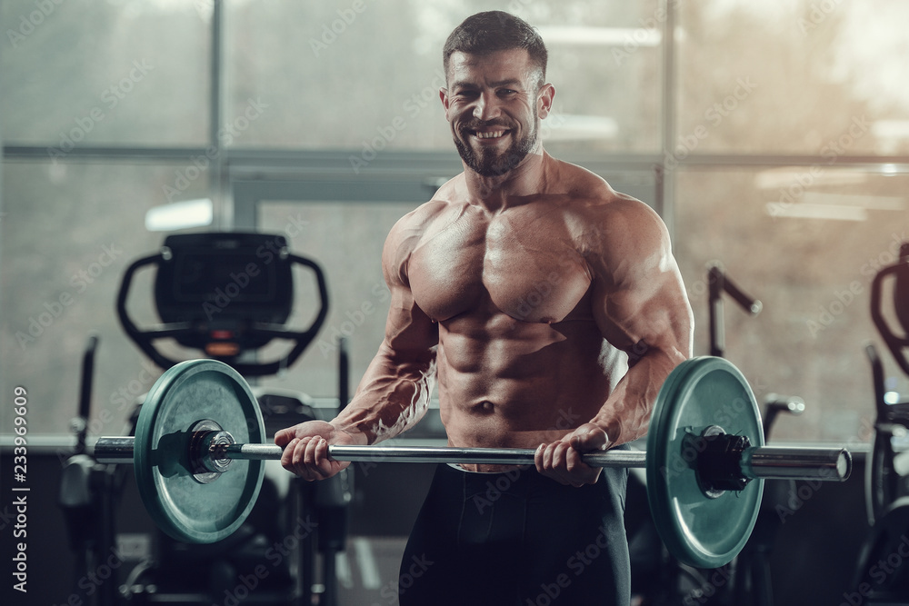 Brutal strong bodybuilder athletic men pumping up muscles with dumbbells