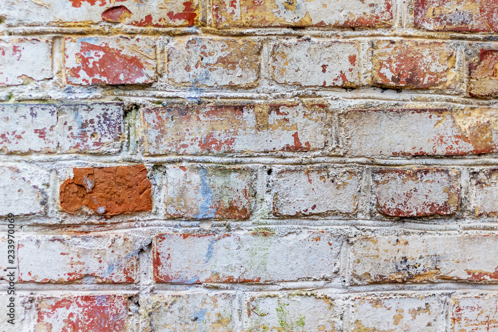 The texture of an old brick wall with traces of old rubbed paint_ The texture of an old brick wall with traces of old rubbed paint_