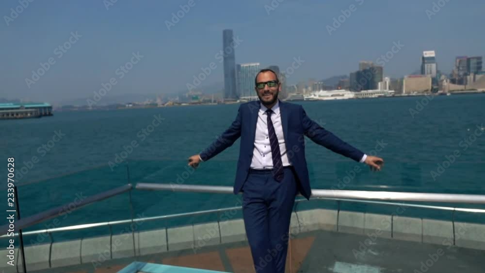 Portrait of happy businessman standing near river, super slow motion 240fps Portrait of happy businessman standing near river, super slow motion 240fps
