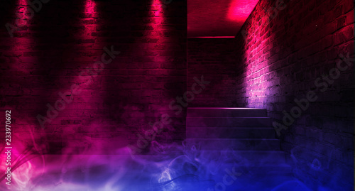A narrow empty corridor, an old brick wall, smoke, neon lights and lamps. Night view. Background of an empty corridor with brick walls and neon light. Brick walls, neon rays and glow
