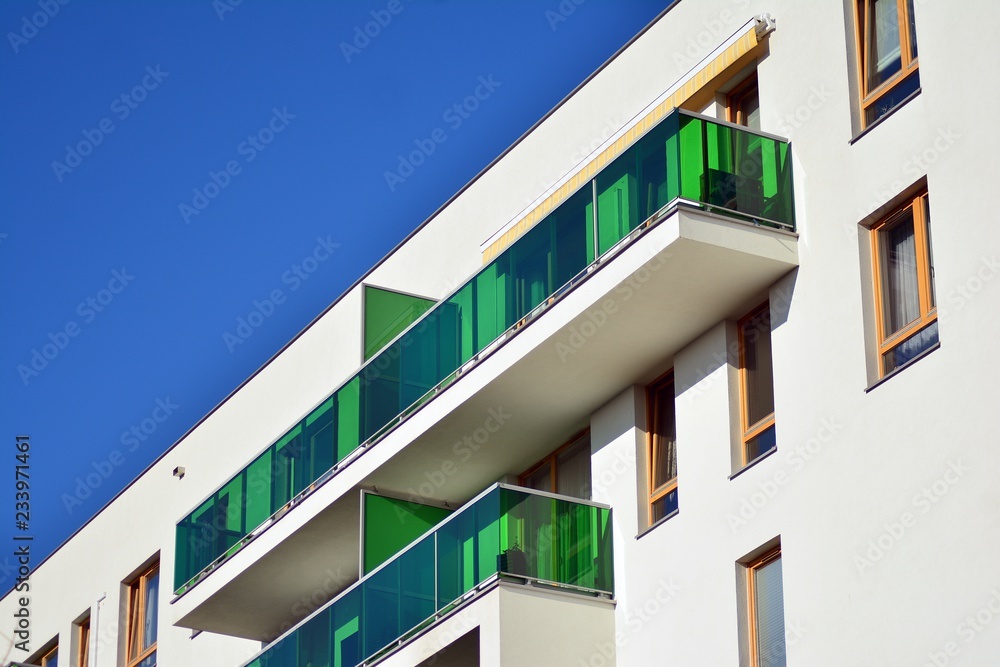 Fragment of a facade of a building with windows and balconies. Modern home with many flats. Fragment of a facade of a building with windows and balconies. Modern home with many flats.
