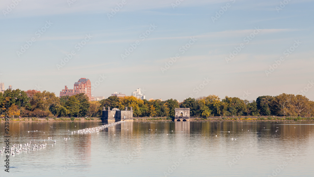 Jackie Onassis Reservoir.  The view across the Jackie Onassis Reservoir in Central Park, New York City on a still autumn morning.